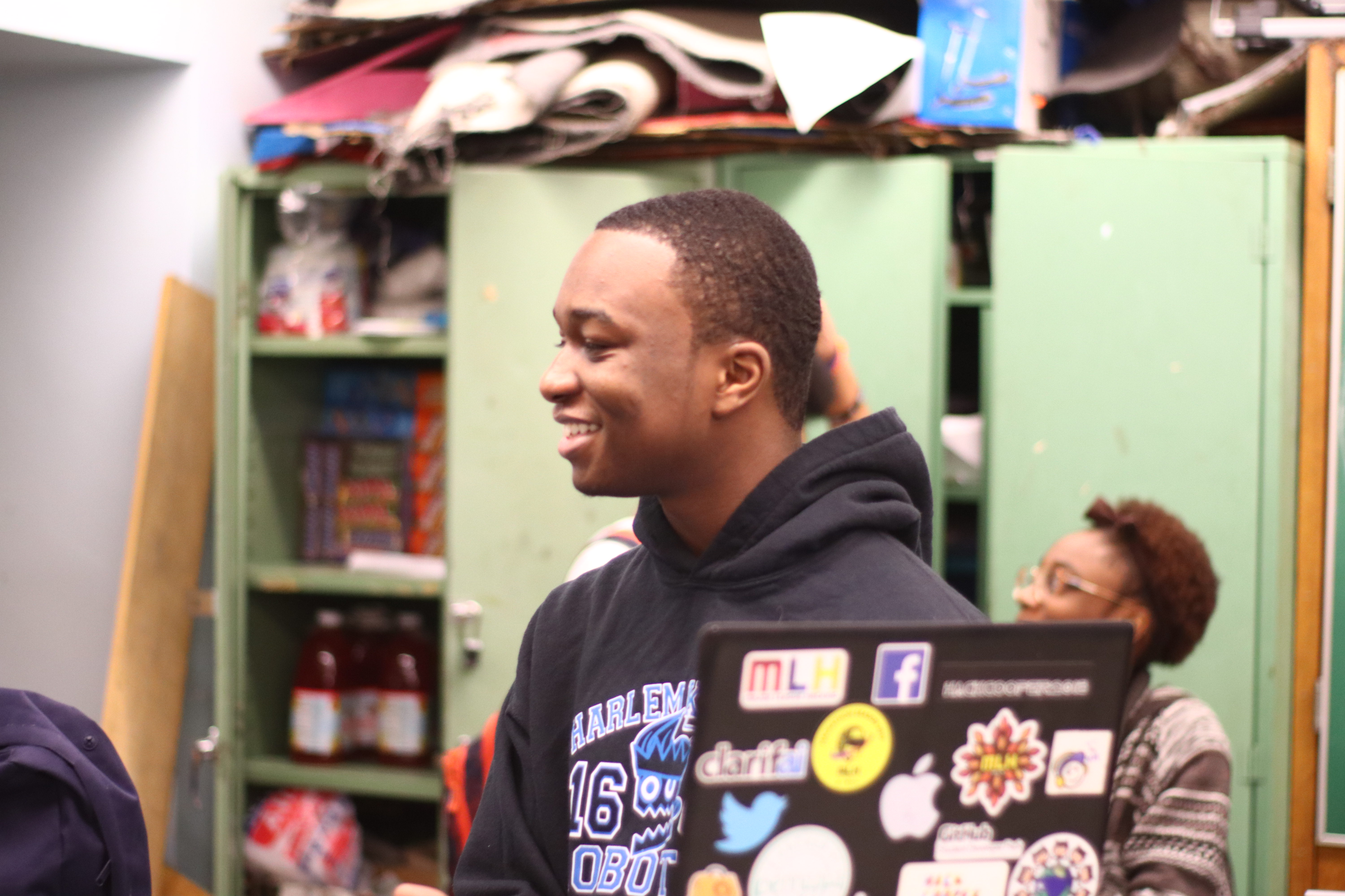 Charles is smiling in the Robotics Room in High-School